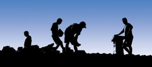 Roofers stand on a roof