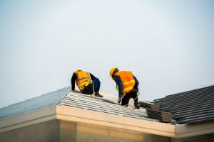 Two workers on a roof