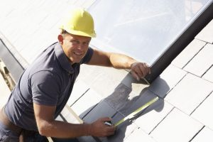 A worker puts down a Slate Roof.