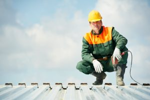 A worker sits on a roof