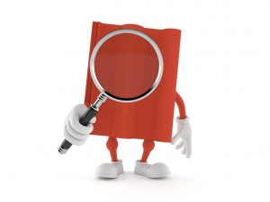 A book holds a magnifying glass