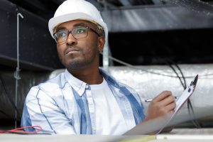 A roofer taking notes